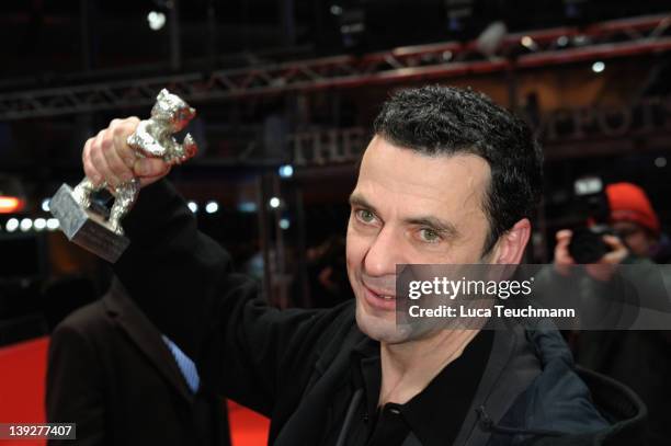 German director Christian Petzold poses with the Silver Bear for Best Director for his movie 'Barbara' at the Award Winners Photocall during day ten...