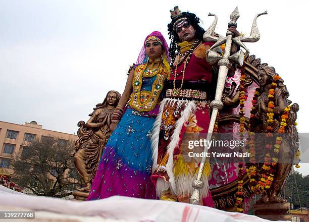 Hindu devotees dressed as Hindu Lord Shiva and Hindu Goddess Parvati participates in Hindu religious procession on the eve of Shivratri festival...