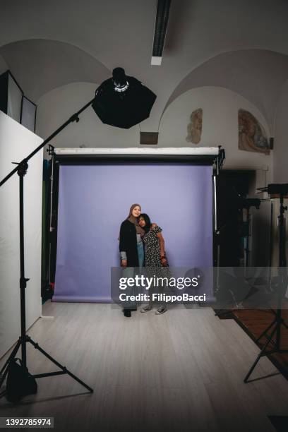 behind the scene shot of two friends while they are having a photoshooting - two people studio shot stock pictures, royalty-free photos & images