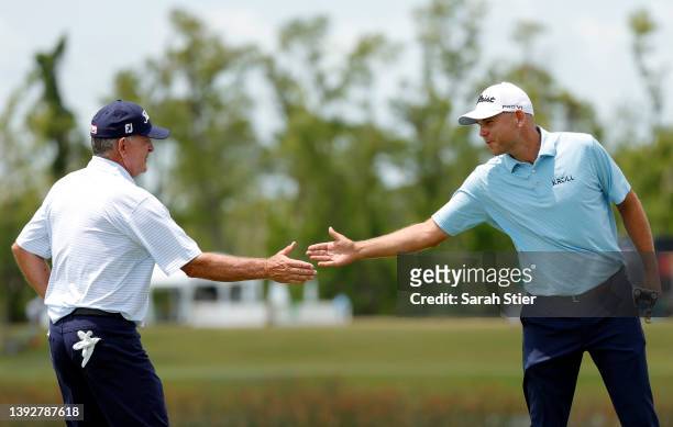 Jay Haas and Bill Haas react on the ninth green during the first round of the Zurich Classic of New Orleans at TPC Louisiana on April 21, 2022 in...