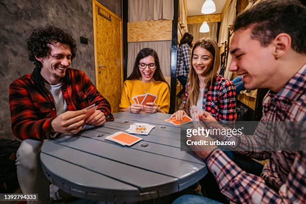 young people playing cards in hostel - college dorm party stock pictures, royalty-free photos & images