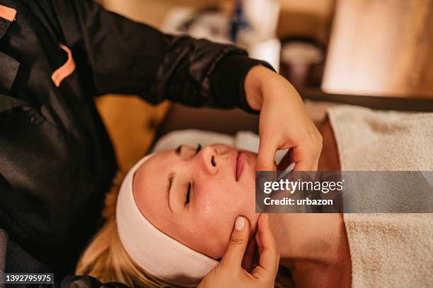 young woman getting head massage - massager stock pictures, royalty-free photos & images