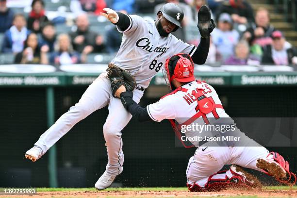 Catcher Jose Ramirez of the Cleveland Guardians tags out Luis Robert of the Chicago White Sox during the fourth inning at Progressive Field on April...