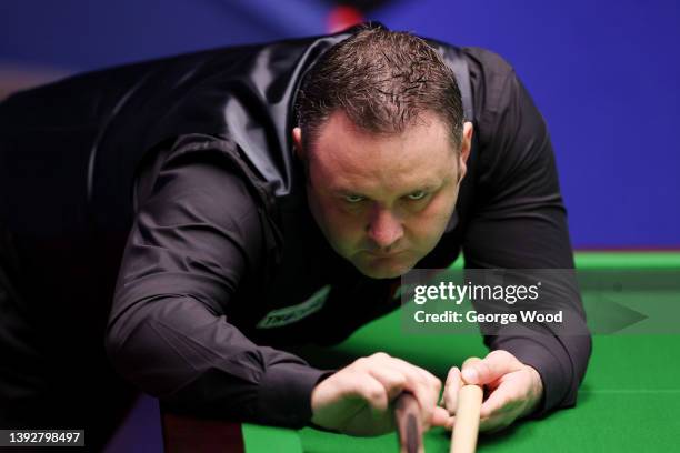 Stephen Maguire of Scotland plays a shot during the Betfred World Snooker Championship Round Two match between Stephen Maguire of Scotland and Zhao...