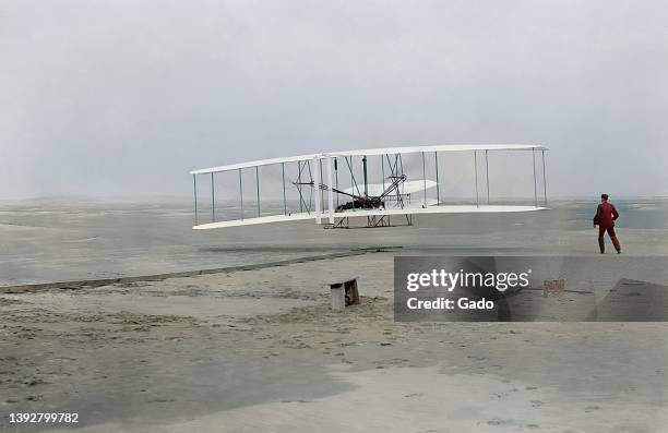 First flight of the Wright Flyer, the first heavier than air airplane to fly, Kill Devil Hills, North Carolina, with Orville Wright controlling the...