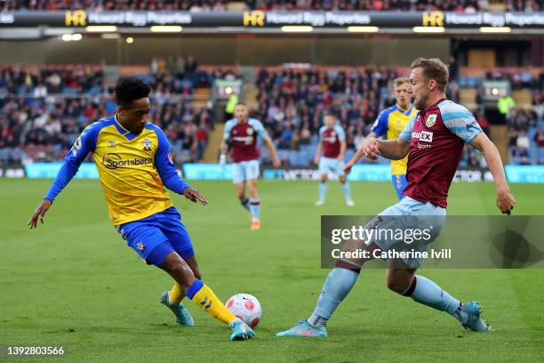 Charlie Taylor of Burnley is challenged by Kyle Walker-Peters of Southampton during the Premier League match between Burnley and Southampton at Turf...