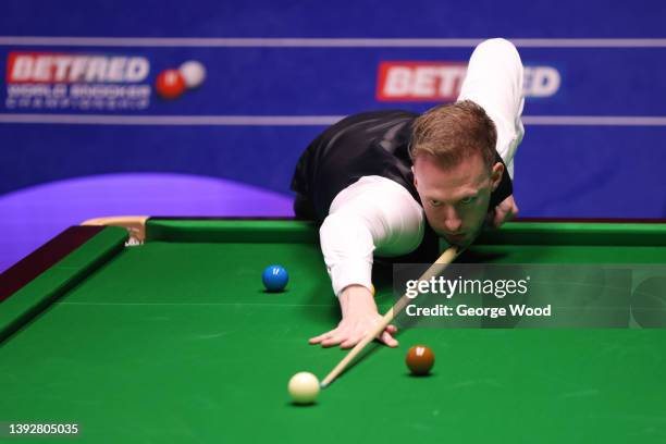 Judd Trump of England plays a shot during the Betfred World Snooker Championship Round One match between Judd Trump of England and Hossein Vafaei of...