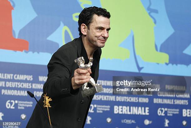 German director Christian Petzold poses with the Silver Bear for Best Director for his movie 'Barbara' at the Award Winners Photocall during day ten...
