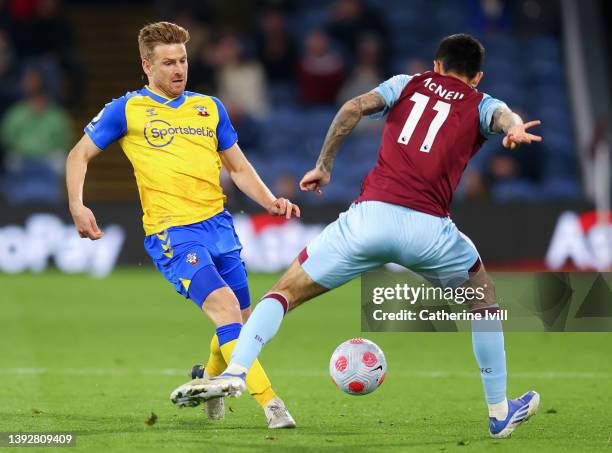 Stuart Armstrong of Southampton makes a pass whilst under pressure from Dwight McNeil of Burnley during the Premier League match between Burnley and...