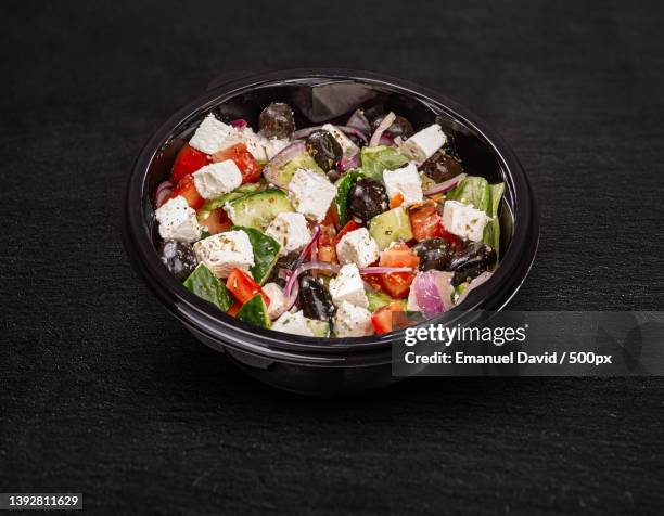 tasty greek salad,high angle view of salad in bowl on table - griechischer salat stock-fotos und bilder