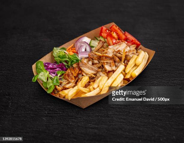 doner kebab on a paper plate - shawarma stock-fotos und bilder