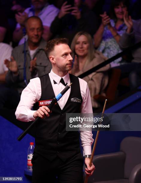Judd Trump of England celebrates after victory in the Betfred World Snooker Championship Round One match between Judd Trump of England and Hossein...