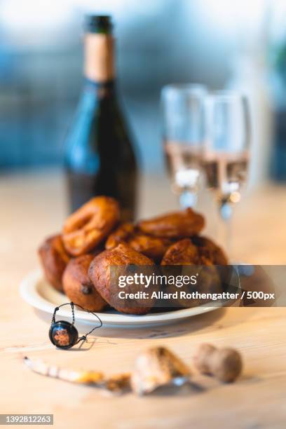 champagne,oliebollen and appelflappen,close-up of food on table - oliebollen stock pictures, royalty-free photos & images