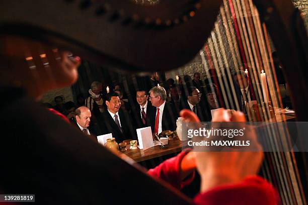 Chinese Vice President Xi Jinping , and Irish Tánaiste Eamon Gilmore and Michael Noonan, Minister for Finance listen to a harpist at Bunratty Castle...