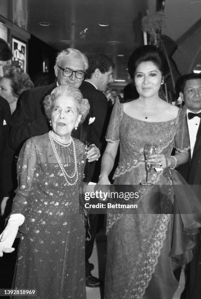 Imelda Marcos, wife of the Philippines president, chats with Mrs. MacArthur, widow of general Douglas MacArthur, during the "The Philippines, Land of...