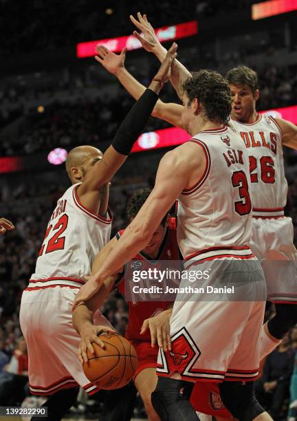Kris Humphries of the New Jersey Nets is trapped by Taj Gibson, Omer Asik and Kyle Korver of the Chicago Bulls at the United Center on February 18,...
