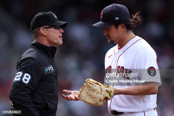 Hirokazu Sawamura of the Boston Red Sox has his glove inspected by umpire Jim Wolf during the seventh inning against the Toronto Blue Jays at Fenway...