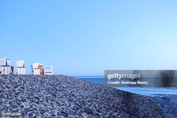 Beach chairs are pictured on the promenade at twillight on April 16, 2022 in Büsum, Germany. In 2009, the Dutch and German parts of the Wadden Sea...