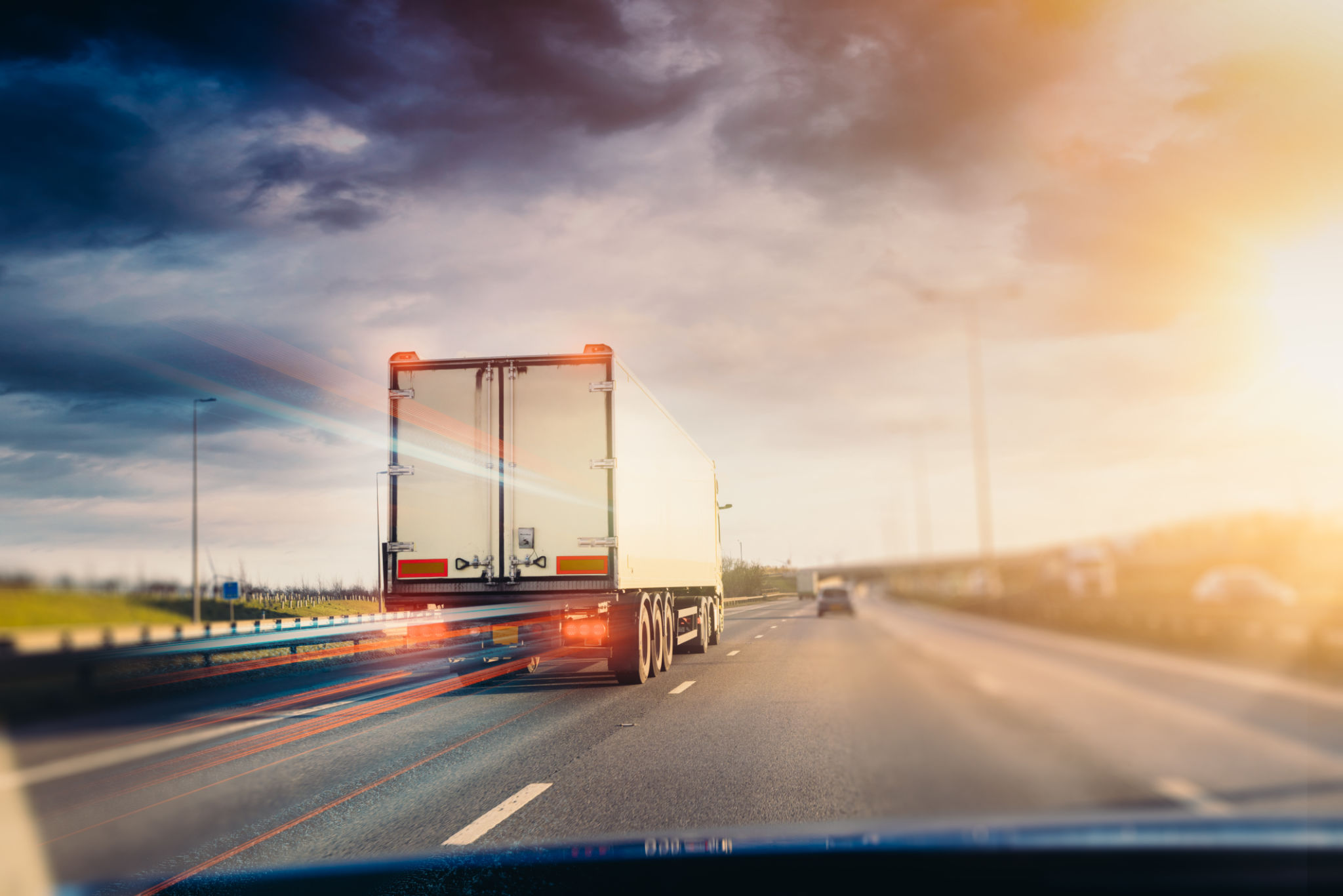 truck driving at sunset