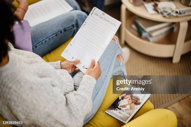 close up of a woman holding book club discussion questions - poetry reading stock pictures, royalty-free photos & images