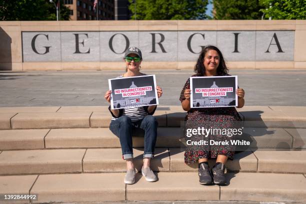 Activists pose as Georgians spell out "Disqualify Greene" in front of the Georgia State Capitol in support of the challenge to Marjorie Taylor...
