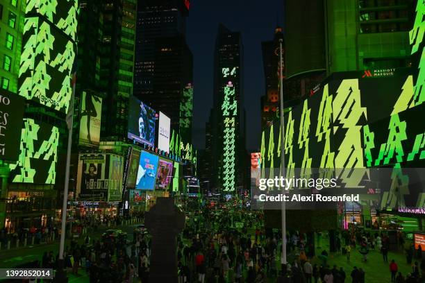 Billboards turn green and display a message in Times Square before going dark for Earth Day on April 21, 2022 in New York City. A total of 19...