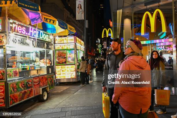 People look at billboards that are dark and display a message in Times Square for Earth Day on April 21, 2022 in New York City. A total of 19...