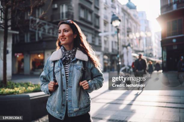 young tourist woman on a city break - jean jacket stock pictures, royalty-free photos & images