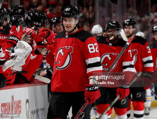 Nikita Okhotiuk of the New Jersey Devils celebrates his first career NHL goal with teammates on the bench during the third period against the Buffalo...