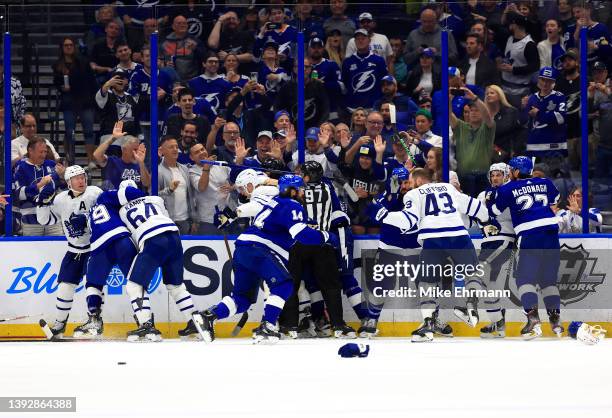 The Tampa Bay Lightning and the Toronto Maple Leafs fight in the third period during a game at Amalie Arena on April 21, 2022 in Tampa, Florida.