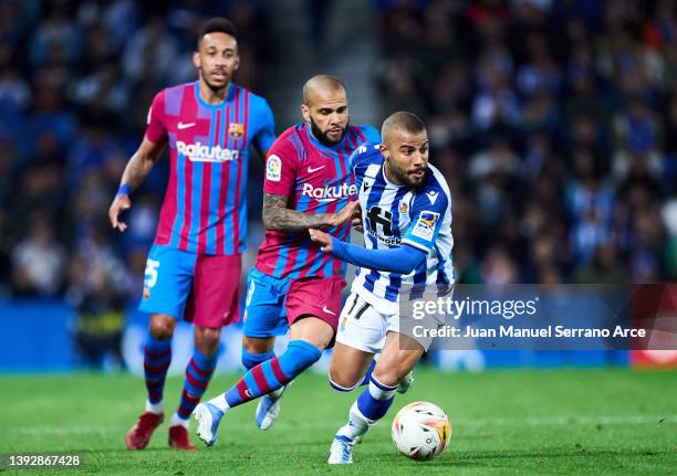 Dani Alves of FC Barcelona duels for the ball with Rafael Alcantara of Real Sociedad during the LaLiga Santander match between Real Sociedad and FC...