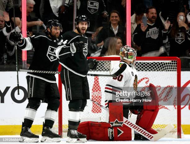 Phillip Danault of the Los Angeles Kings celebrates his goal with Alex Iafallo in front of Collin Delia of the Chicago Blackhawks, to take a 1-0...