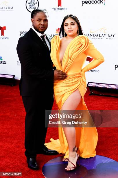 Akim and a guest arrive at the 2022 Latin American Music Awards at Michelob ULTRA Arena on April 21, 2022 in Las Vegas, Nevada.