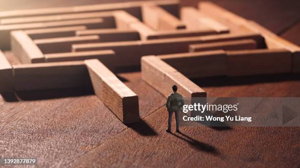 miniature business man maze solution concept photo - tough decisions stock pictures, royalty-free photos & images