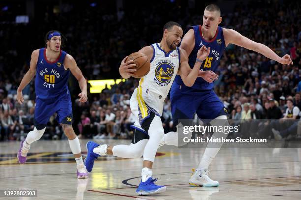 Stephen Curry of the Golden State Warriors drives against Nikola Jokic of the Denver Nuggets in the fourth quarter during Game Three of the Western...