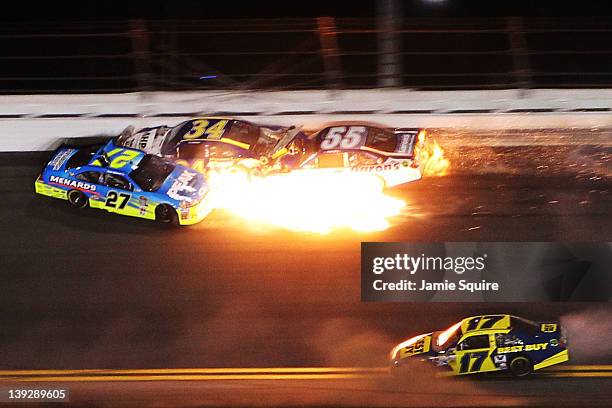 Paul Menard, driver of the Peak/Menards Chevrolet spins, while David Ragan, driver of the Front Row Motorsports Ford and Michael Waltrip, driver of...