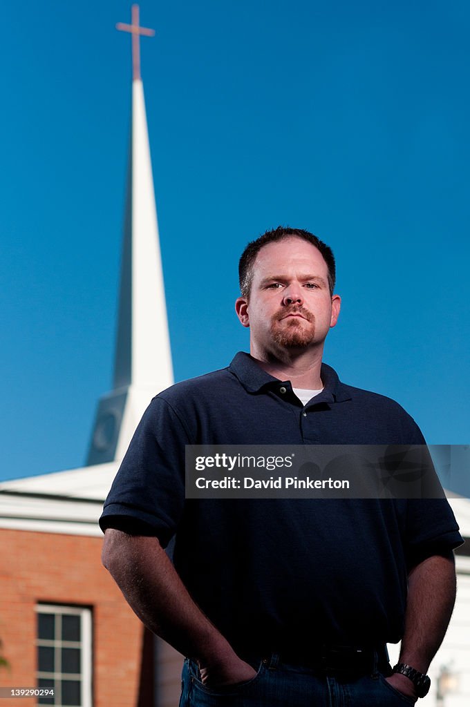 Pastor standing in front of his church