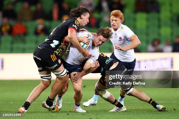 Michael Hooper of the Waratahs is tackled by Josh Lord of the Chiefs during the round 10 Super Rugby Pacific match between the Chiefs and the NSW...