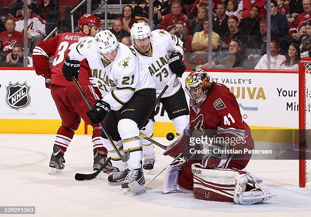 Loui Eriksson and Michael Ryder of the Dallas Stars follow the puck as it hits goaltender Mike Smith of the Phoenix Coyotes during the second period...