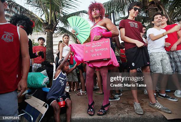 Boy lifts a Brazilian reveler's skirt during Carnival celebrations along Ipanema beach on February 18, 2012 in Rio de Janiero, Brazil. Carnival is...