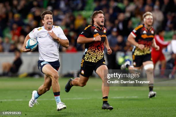 Jake Gordon of the Waratahs runs clear to score a try during the round 10 Super Rugby Pacific match between the Chiefs and the NSW Waratahs at AAMI...