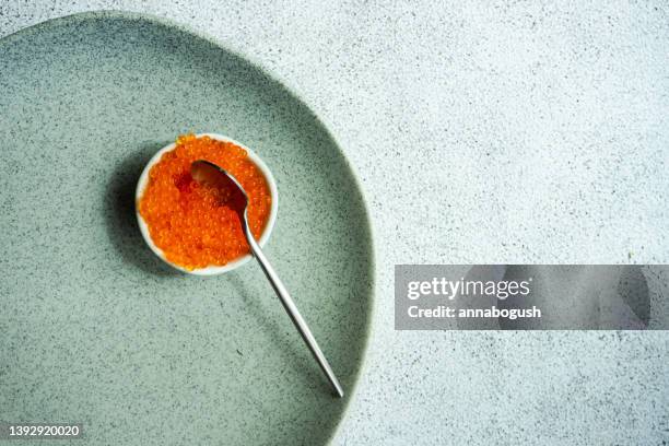 overhead view of a bowl of red trout caviar on a plate - trout stock pictures, royalty-free photos & images