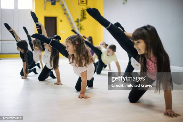 children practicing in dancing in studio. - floor gymnastics stock pictures, royalty-free photos & images