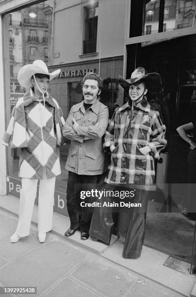 Spanish designer Paco Rabanne with two models in Paris.