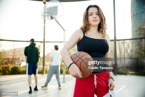 a streetball player portriat in the city court. - streetball stock pictures, royalty-free photos & images