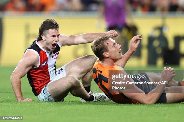 Jack Higgins of the Saints celebrates kicking a goal over Lachlan Keeffe of the Giants during the round six AFL match between the Greater Western...