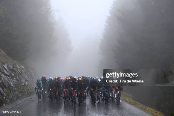 Pello Bilbao López De Armentia of Spain and Team Bahrain Victorious Green Leader Jersey with teammates lead the peloton passing through a forest...