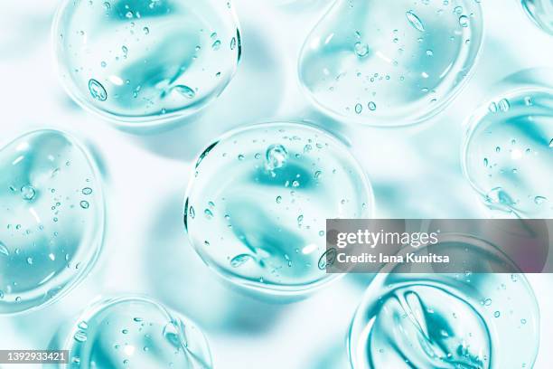 transparent blue moisture face serum smeared. hydrating hyaluronic acid. hair gel with bubbles. cosmetic products for makeup and skin care. cosmetology. - gel stock pictures, royalty-free photos & images