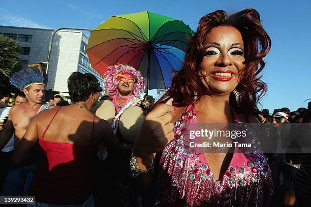 Brazilian revelers walk during Carnival celebrations along Ipanema beach on February 18, 2012 in Rio de Janiero, Brazil. Carnival is the grandest...