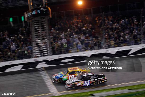 Kyle Busch, driver of the M&M's Brown Toyota, edges out Tony Stewart, driver of the Office Depot/Mobil 1 Chevrolet, to win the NASCAR Budweiser...